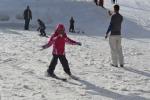 Kids having a blast with skies and snowboards