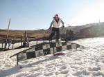 Snowboarder going down the rail